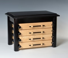 Pagoda style jewelry box with light wooden drawers and a black top and sides