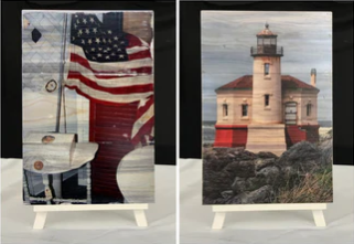 two blue pine wood art prints with transferred images of a lighthouse (right) and a flag (left)