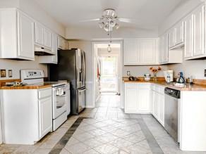 Refinished white cabinet kitchen with stainless steal appliances and wood countertops