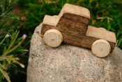 small wooden toy truck on a rock